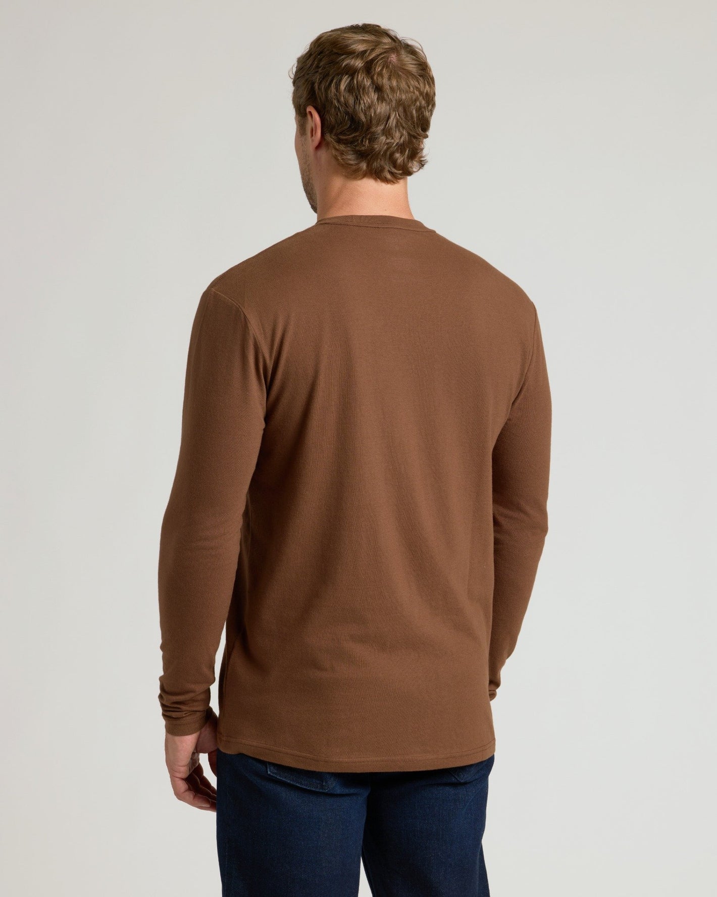Man wearing Sepiawood Classic Long Sleeve Crew Neck, seen from behind.