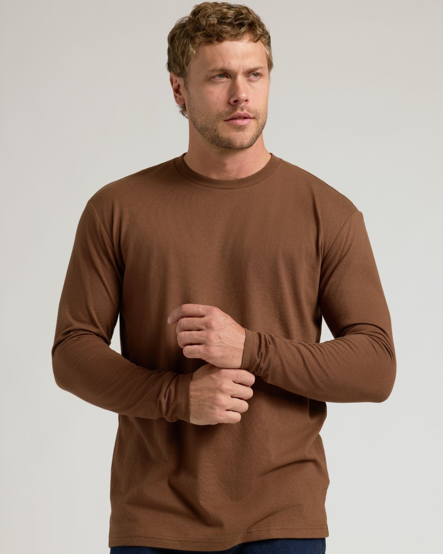 Sepiawood Classic Long Sleeve Crew Neck on man adjusting sleeve.