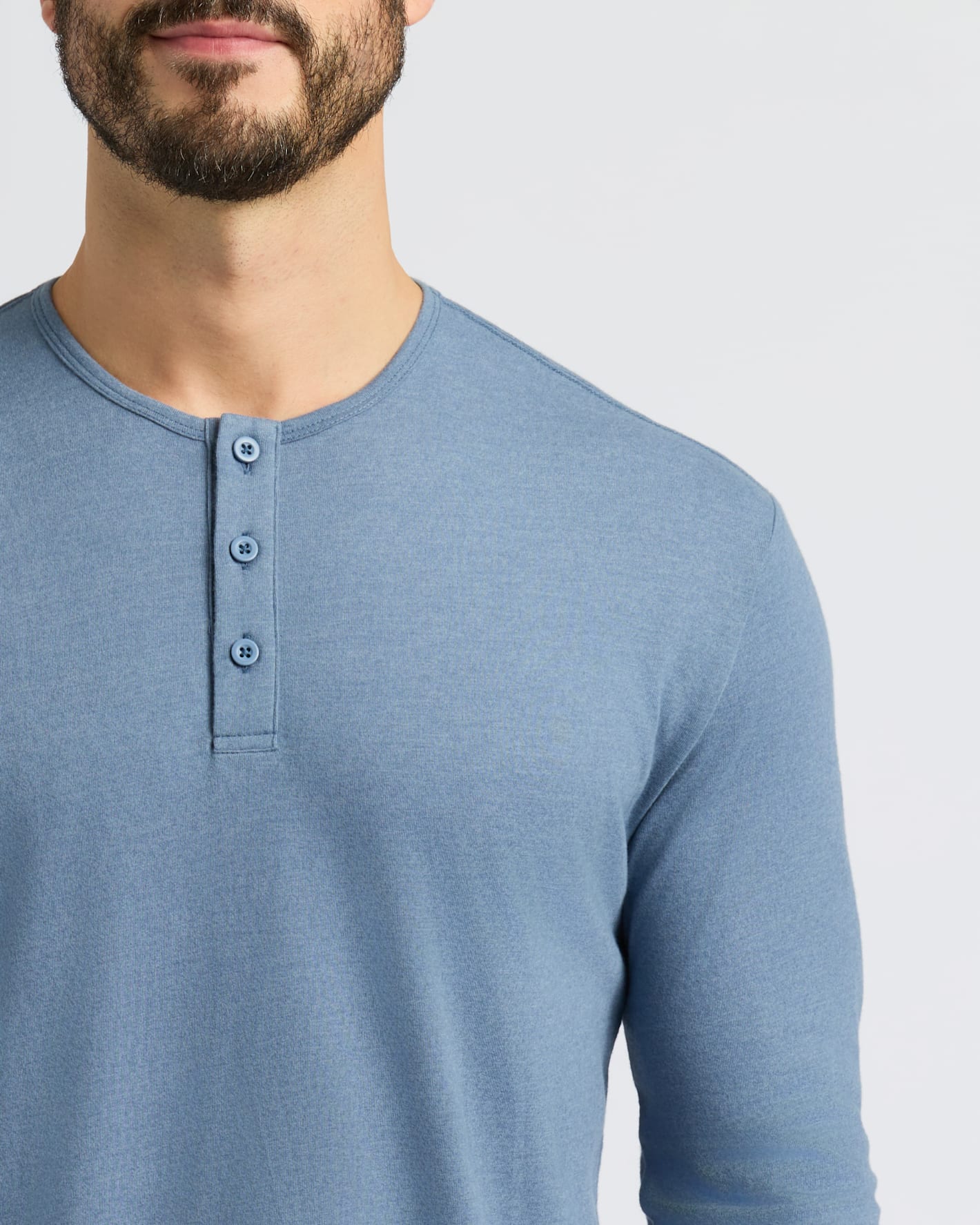 Man wearing Dark Heather Vintage Navy Classic Long Sleeve Henley shirt.