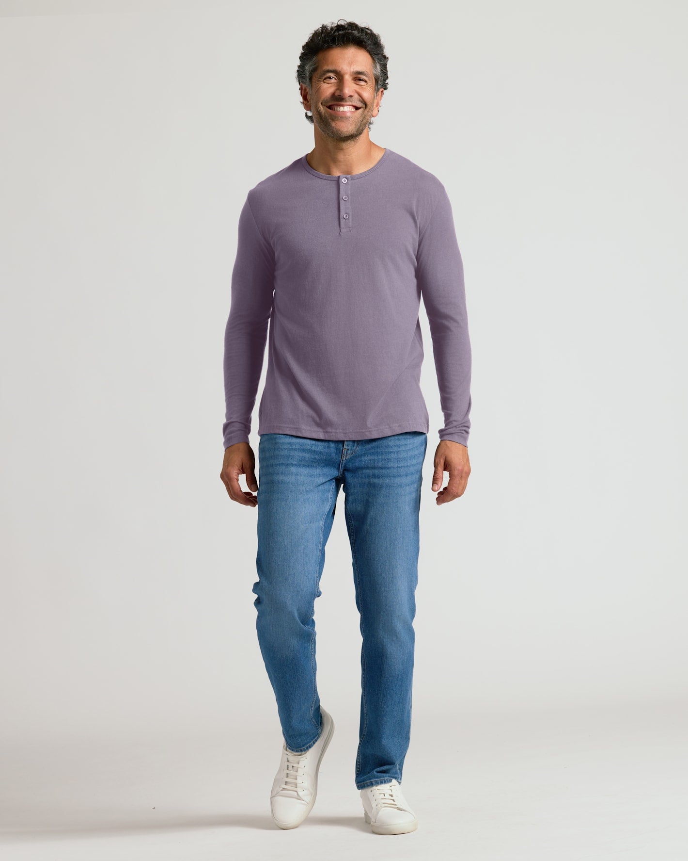 Man wearing Seasonal Classic Long Sleeve Henley, showcasing relaxed fit.