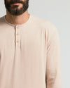 Man wearing Heather Camel Classic Long Sleeve Henley with buttoned neckline.