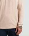 Heather Camel Classic Long Sleeve Henley worn with navy pants, showcasing mandala tattoo.