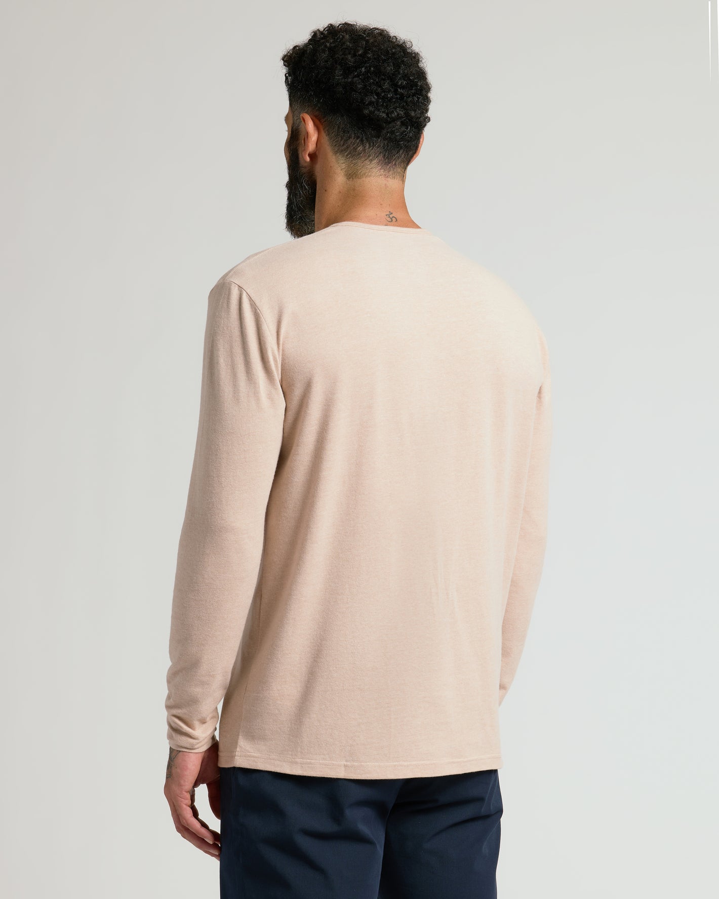 Back view of man wearing Heather Camel Classic Long Sleeve Henley.