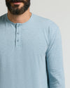 Man wearing Heather Sapphire Classic Long Sleeve Henley with a three-button placket.