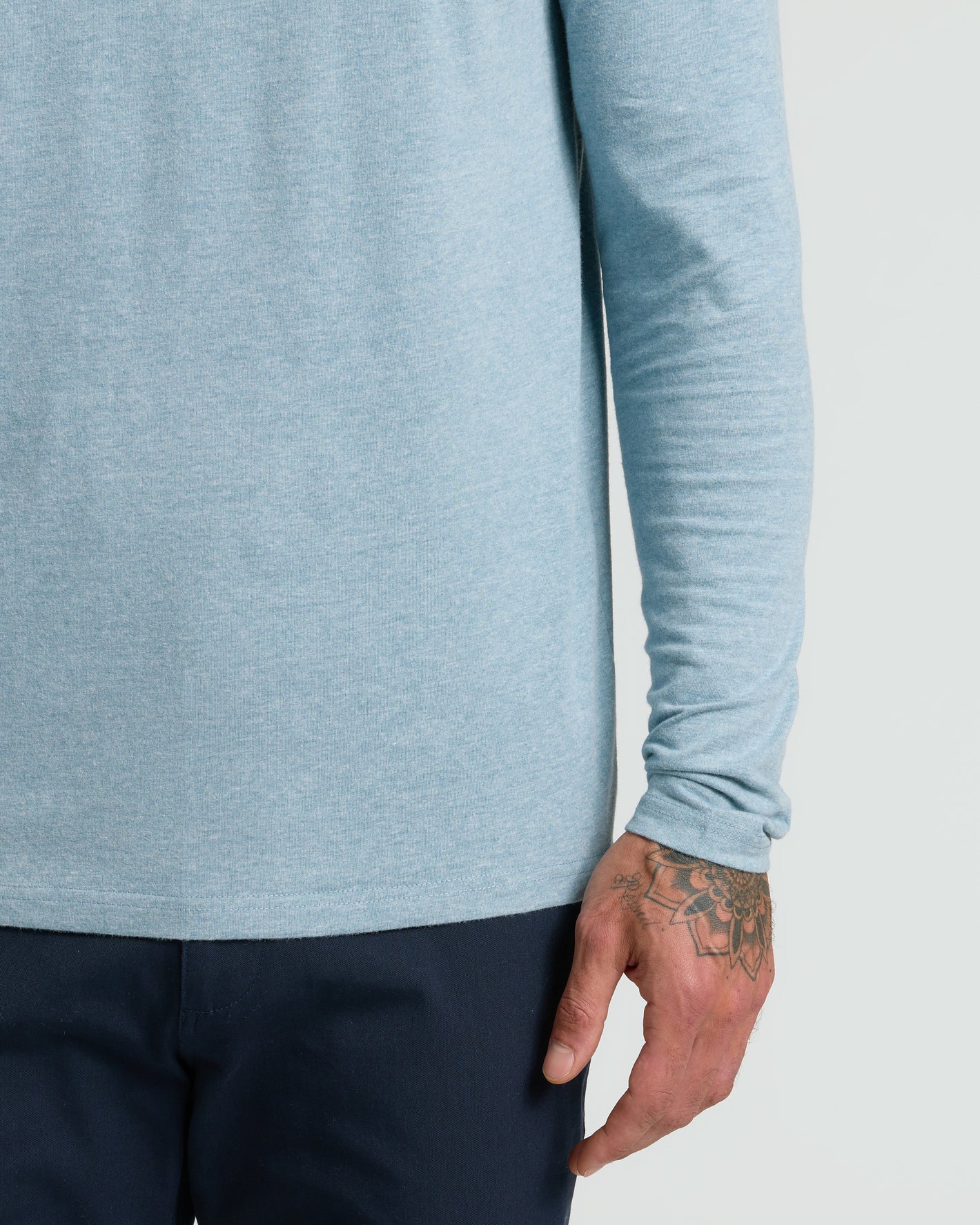 Heather Sapphire Classic Long Sleeve Henley on person with floral hand tattoo.