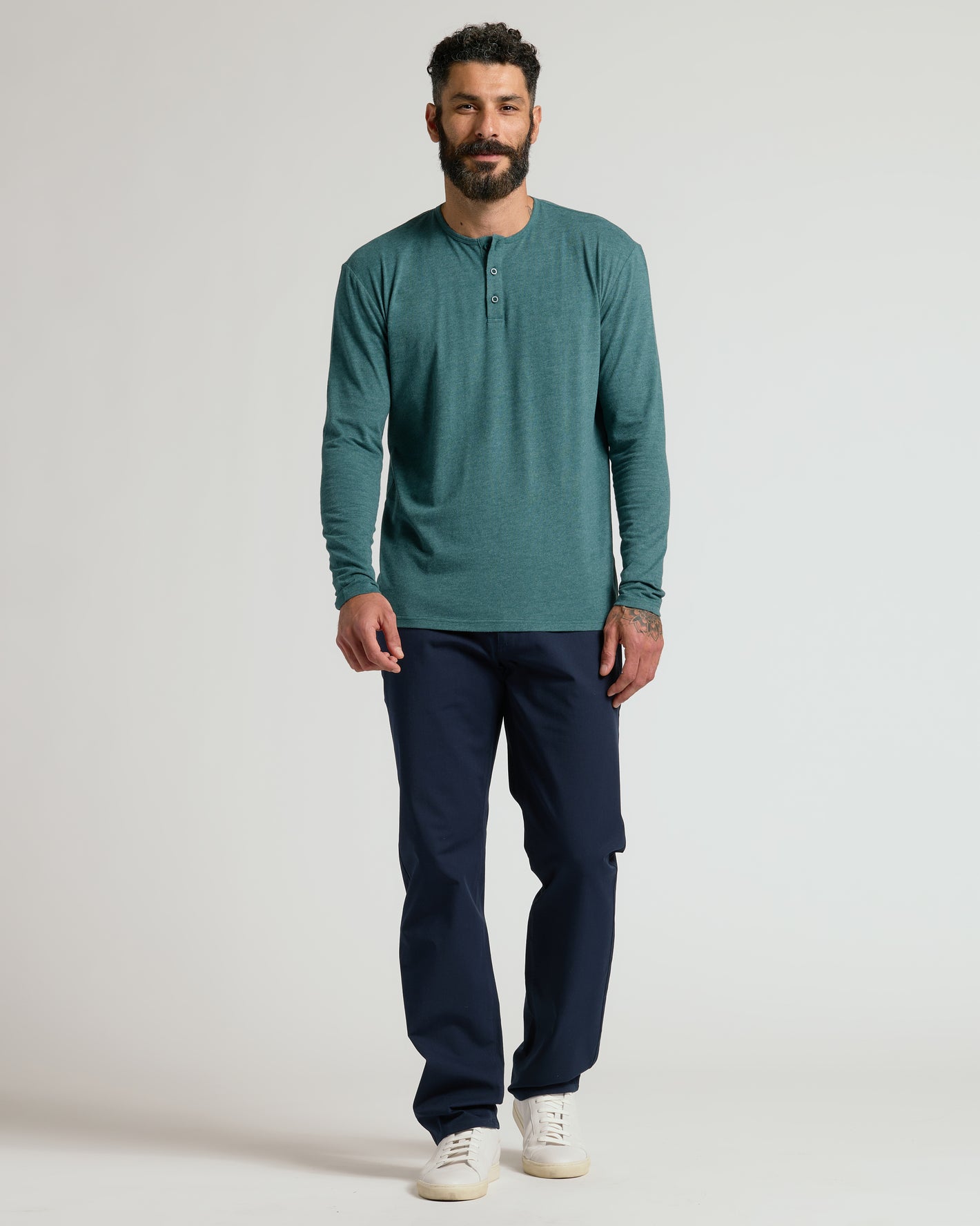 Model in Heather Seafarer Classic Long Sleeve Henley and navy trousers.