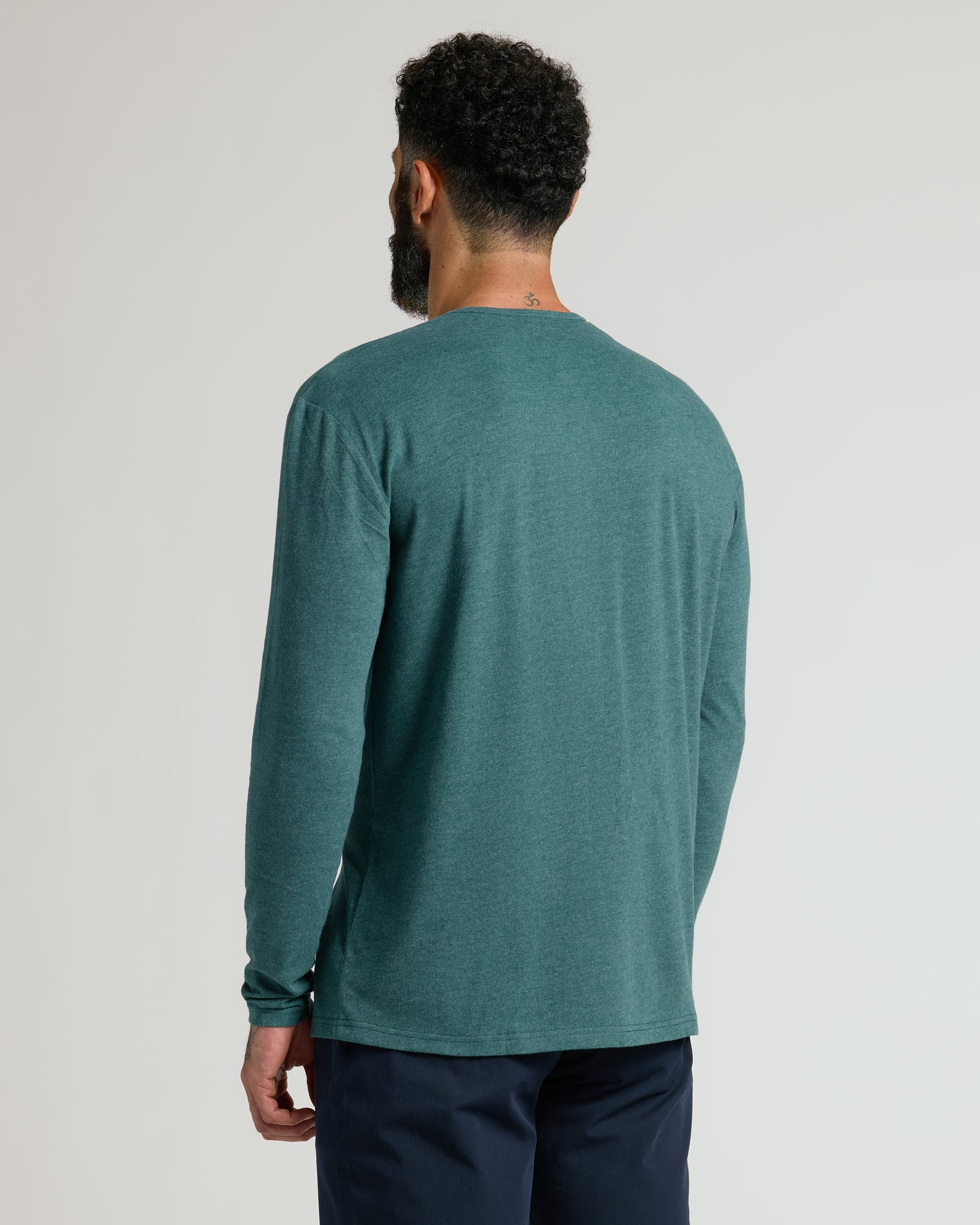 Man wearing Heather Seafarer Classic Long Sleeve Henley, back view.