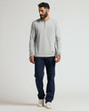 Male model wearing Steel Classic Long Sleeve Henley, navy trousers, white sneakers.