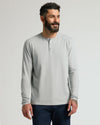 Man in Steel Classic Long Sleeve Henley, showcasing minimalist style.