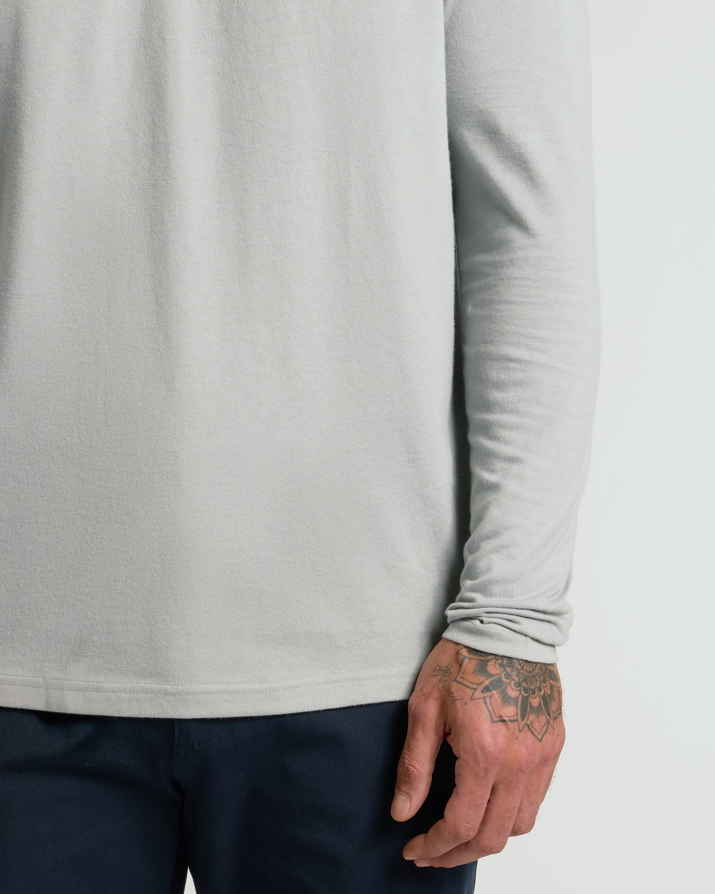 Steel Classic Long Sleeve Henley worn, showcasing geometric floral hand tattoo.