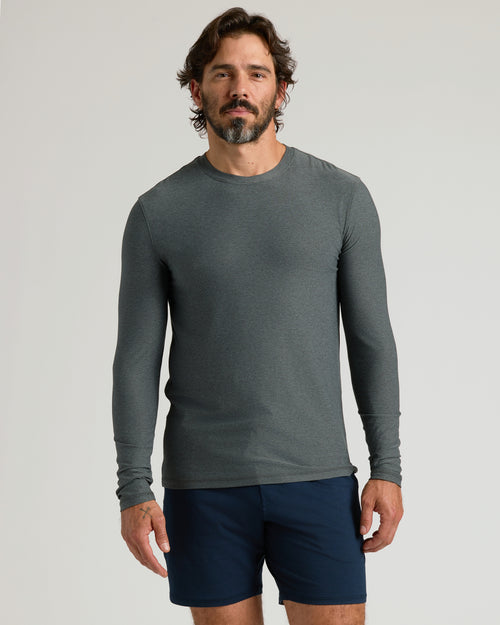Man wearing Charcoal Heather Gray Active Long Sleeve Crew T-Shirt, navy shorts.