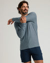 Man wearing Active Long Sleeve Crew 3-Pack shirt stretching.