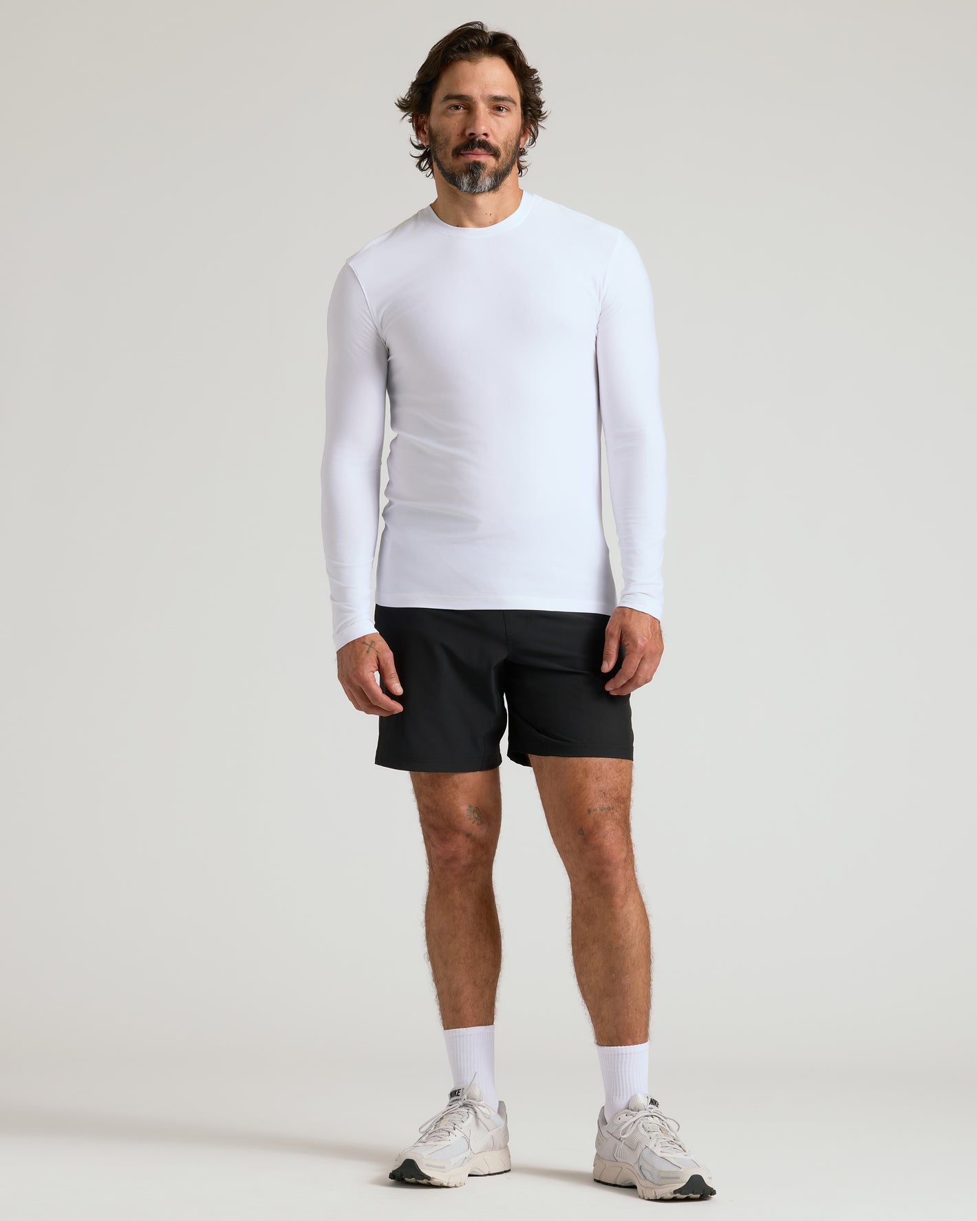 Model in Active Long Sleeve Crew 3-Pack, white top, black shorts.