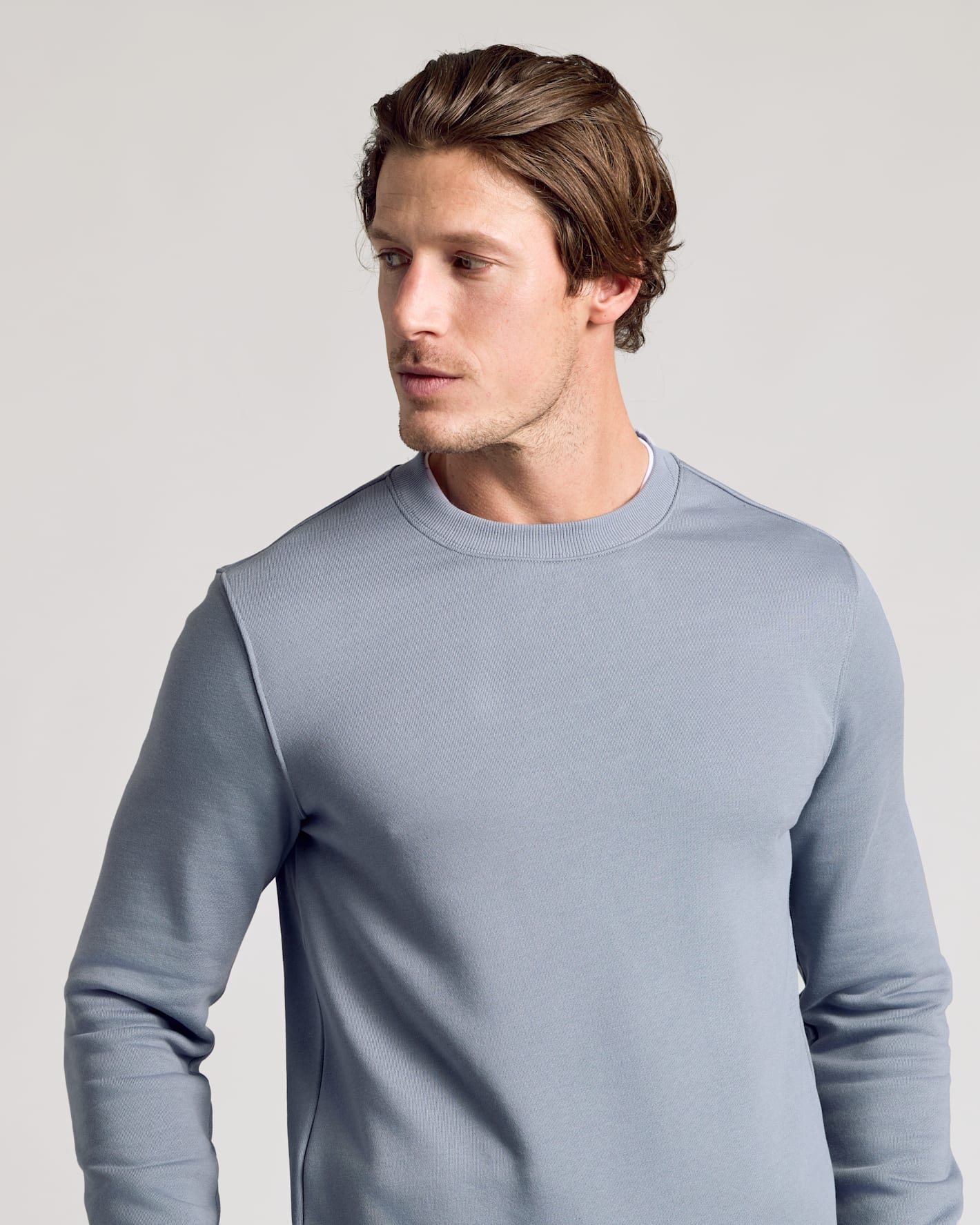 Young man wearing Dusty Blue Fleece French Terry Pullover Crew Neck.