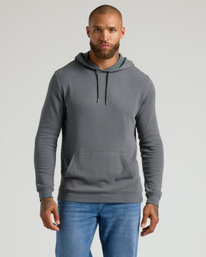Man wearing Carbon Waffle Hoodie with front pocket and drawstring hood.
