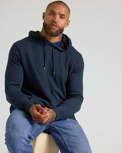 True ClassicMan wearing Heather Gray & Navy Waffle Hoodie, seated, showing hoodie features.