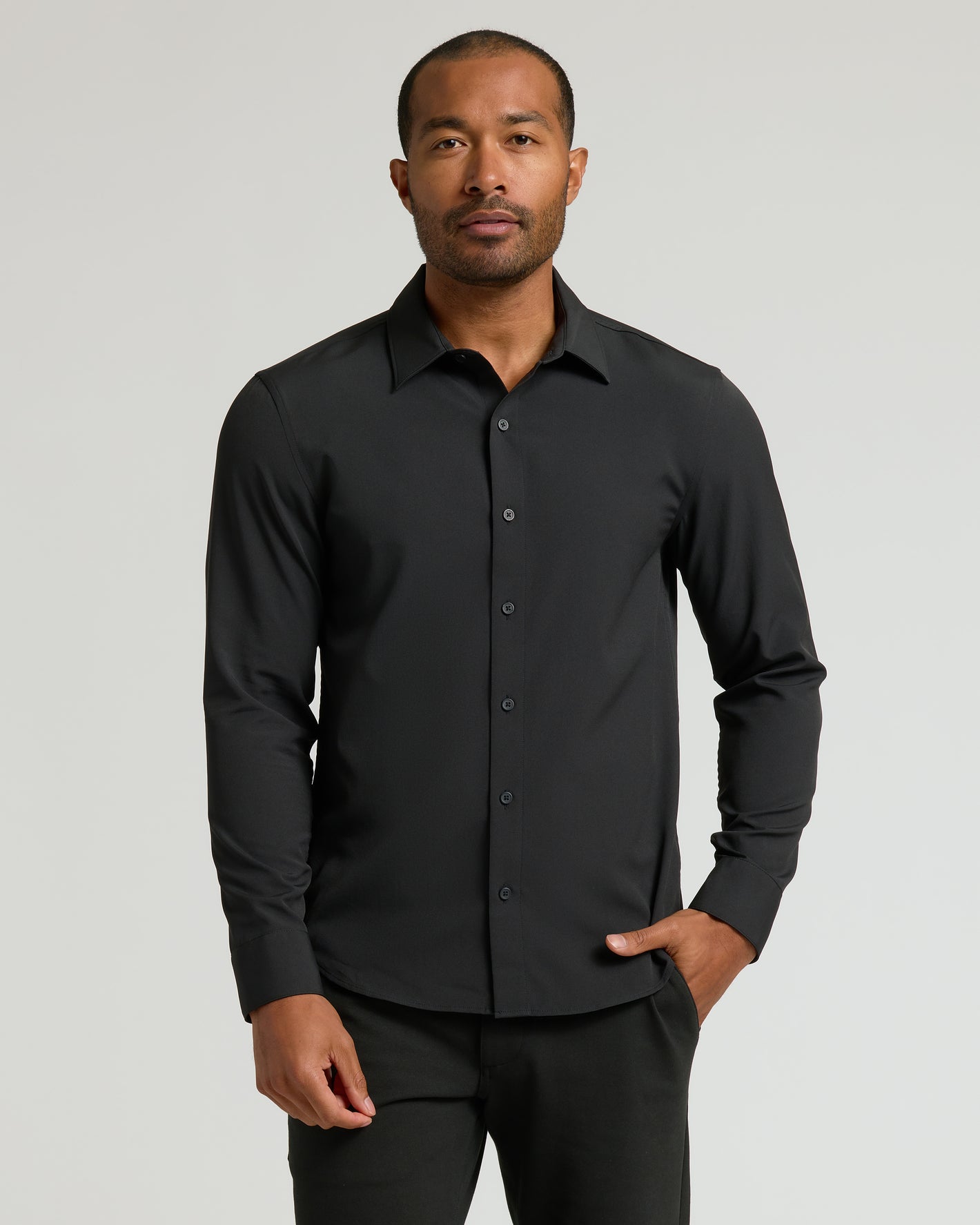 Man in Staple Long Sleeve Performance Dress Shirt, hands relaxed.