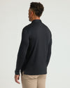 Back view of model in All Black Long Sleeve Premium Pima Polo.