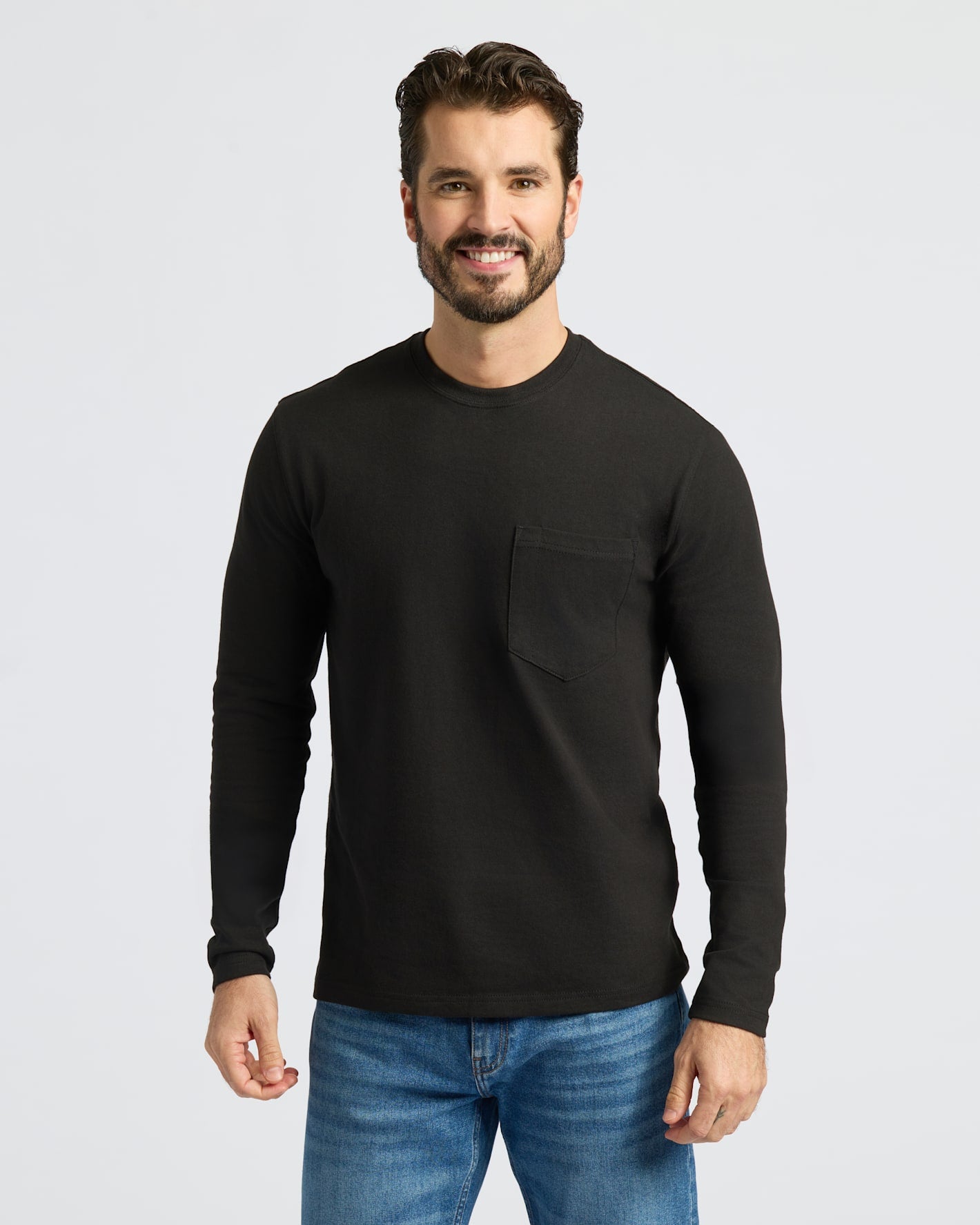 Man in Black & Navy Heavyweight Long Sleeve Pocket Crew, smiling.