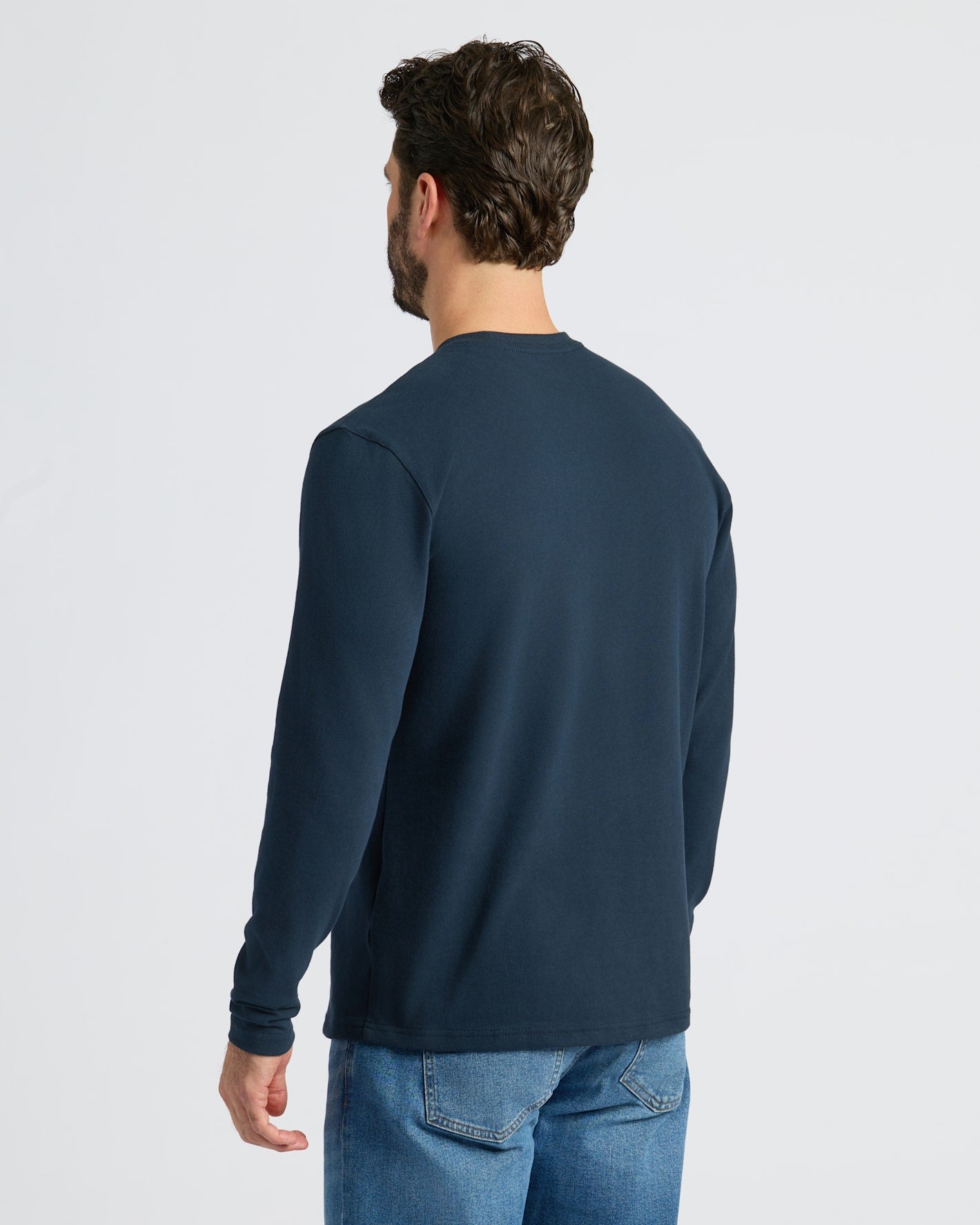 Back view of man in Navy Heavyweight Long Sleeve Pocket Crew.