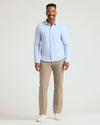 Man wearing Blue Stripe Stretch Oxford 2.0 shirt and beige trousers.