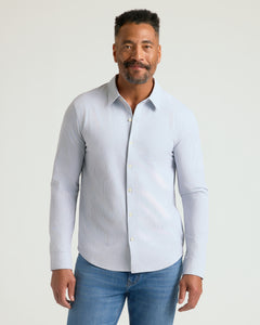 True ClassicMan wearing Long Sleeve Stretch Oxford, light-blue pinstriped shirt, medium-blue jeans.
