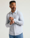 Man models Long Sleeve Stretch Oxford 2-Pack shirt, fastening cuff.