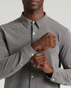 Man fastening cuff of Oak Stretch Oxford 2.0 shirt.
