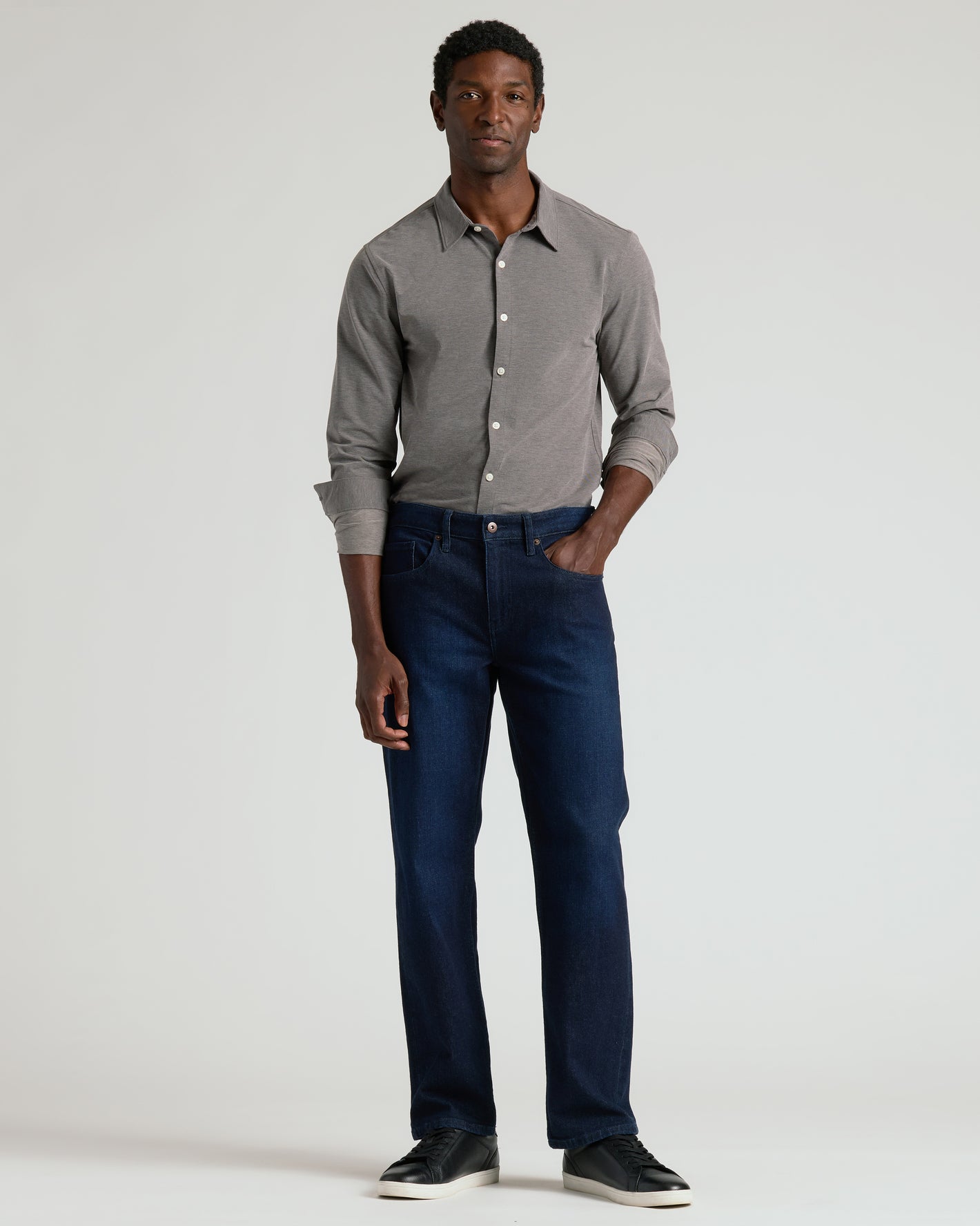Man wearing Oak Stretch Oxford 2.0 shirt with jeans and sneakers.