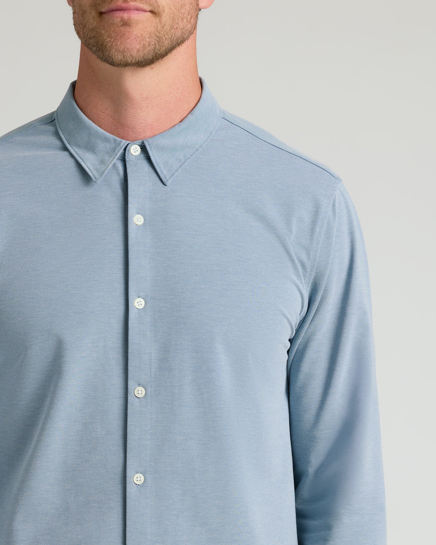Blue Stretch Oxford 2.0 shirt with pointed collar, visible buttons.