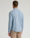 Blue Stretch Oxford 2.0 shirt paired with khaki trousers, back view.