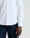 White Stretch Oxford 2.0 shirt with buttons, paired with dark jeans.