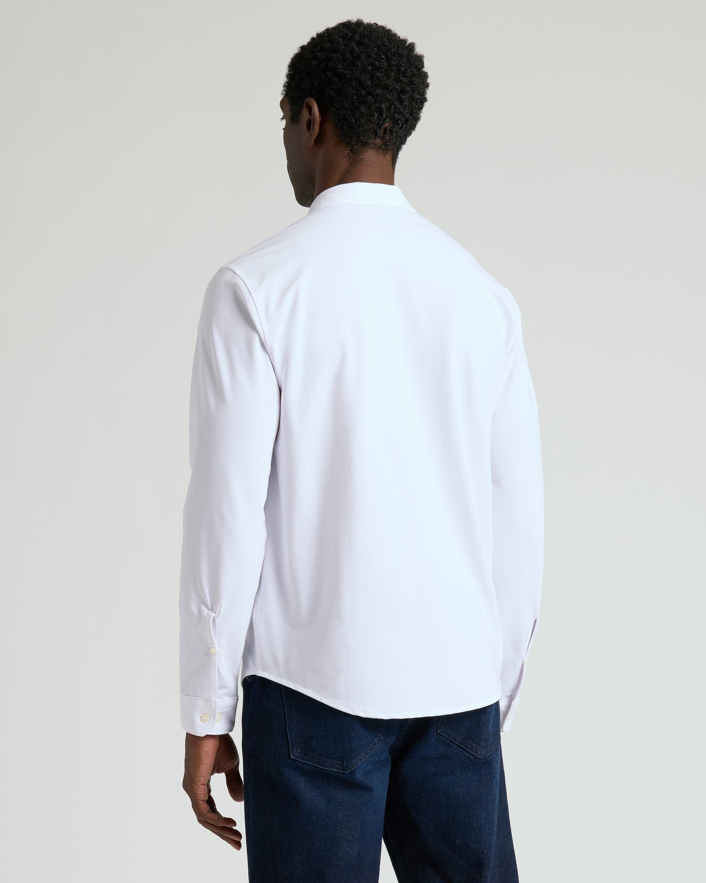 Back view of man in White Stretch Long Sleeve Modern Knit Oxford.