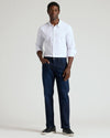 Man wearing White Stretch Oxford 2.0, rolled sleeves, blue jeans.