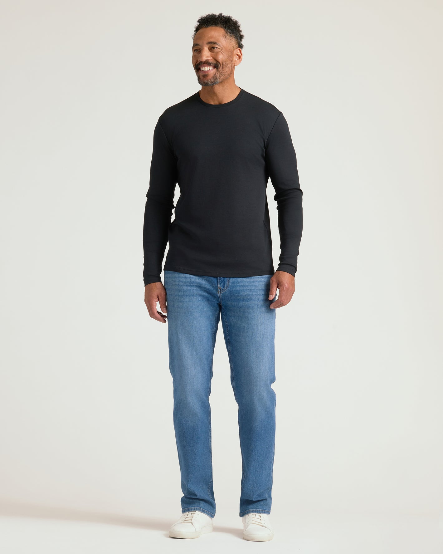 Man wearing Premium Pima Long Sleeve Crew, showcasing its snug fit.