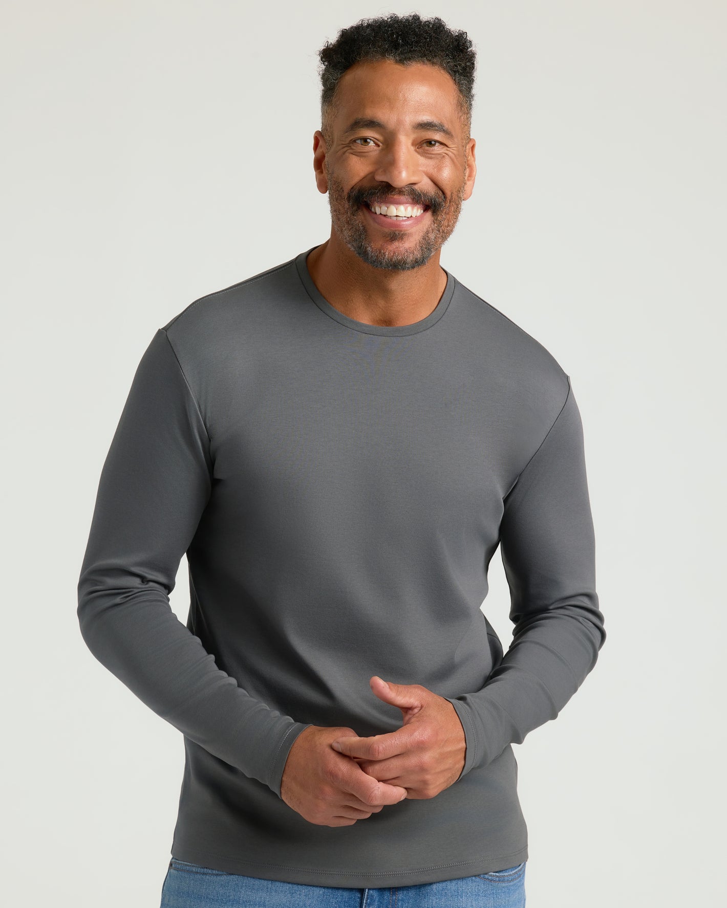 Man wearing Carbon Premium Pima Long Sleeve Crew, fitted and stylish.