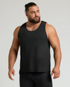 Muscular man wearing The Standard Sleeveless Active Mesh Tank, showcasing athletic cut.