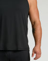 Black Sleeveless Active Mesh Tank with tattooed arm, light-gray backdrop.