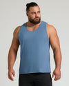 Muscular man in The Staple Sleeveless Active Mesh Tank 3-Pack.