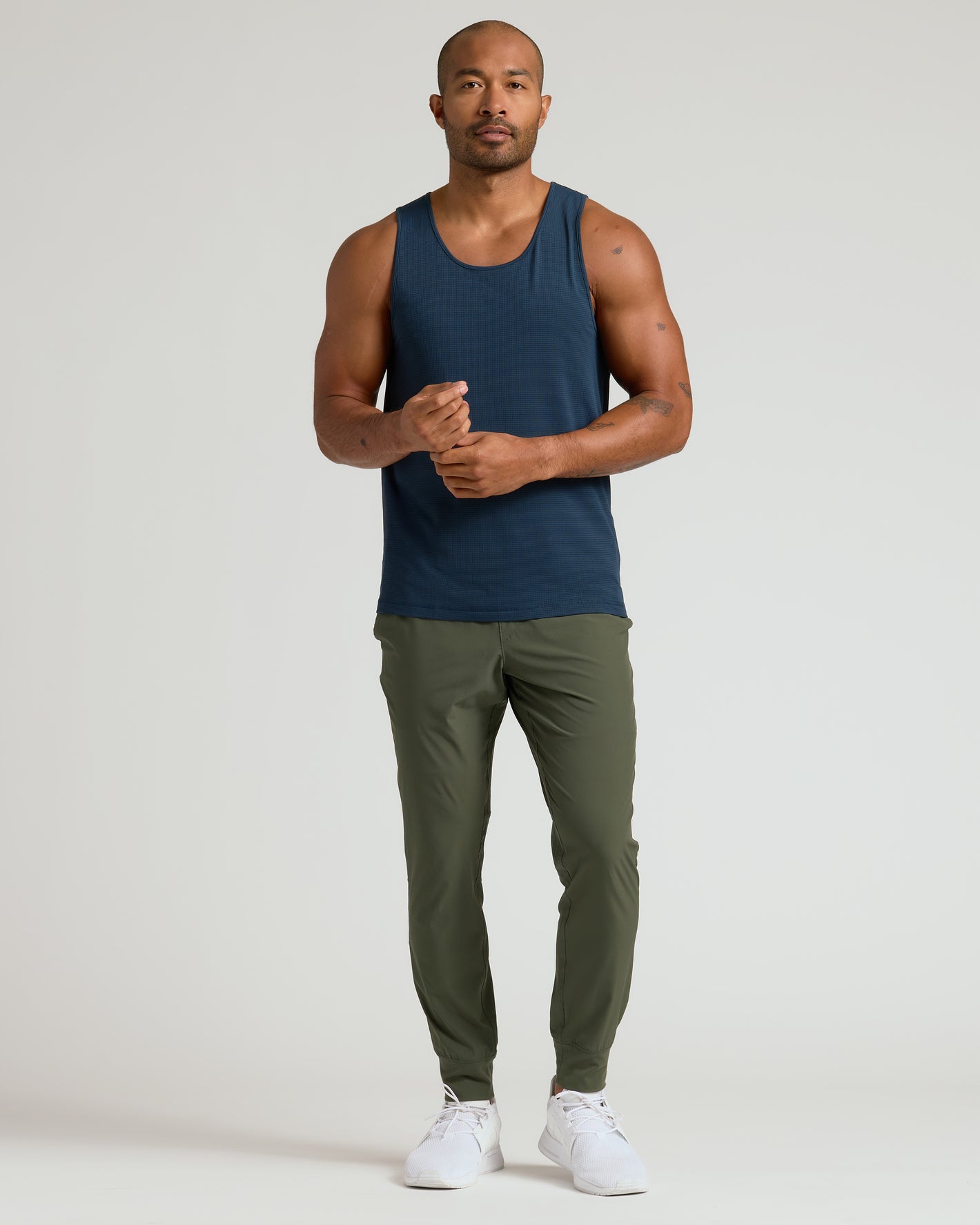 Man wearing All Navy Active Mesh Tank, showcasing its athletic fit and style.
