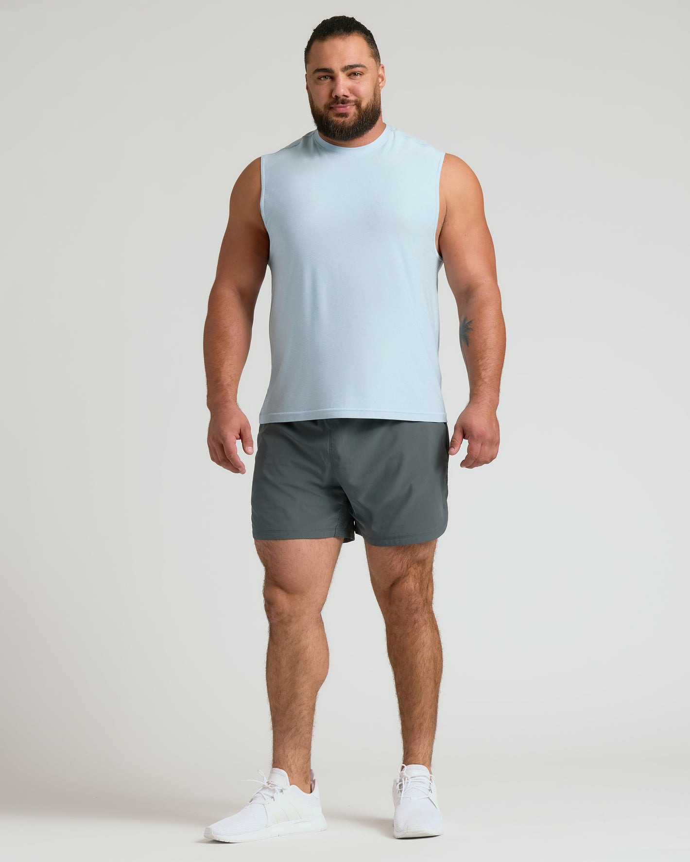 Man wearing Arctic Sleeveless Active Muscle Tee, showcasing athletic fit.