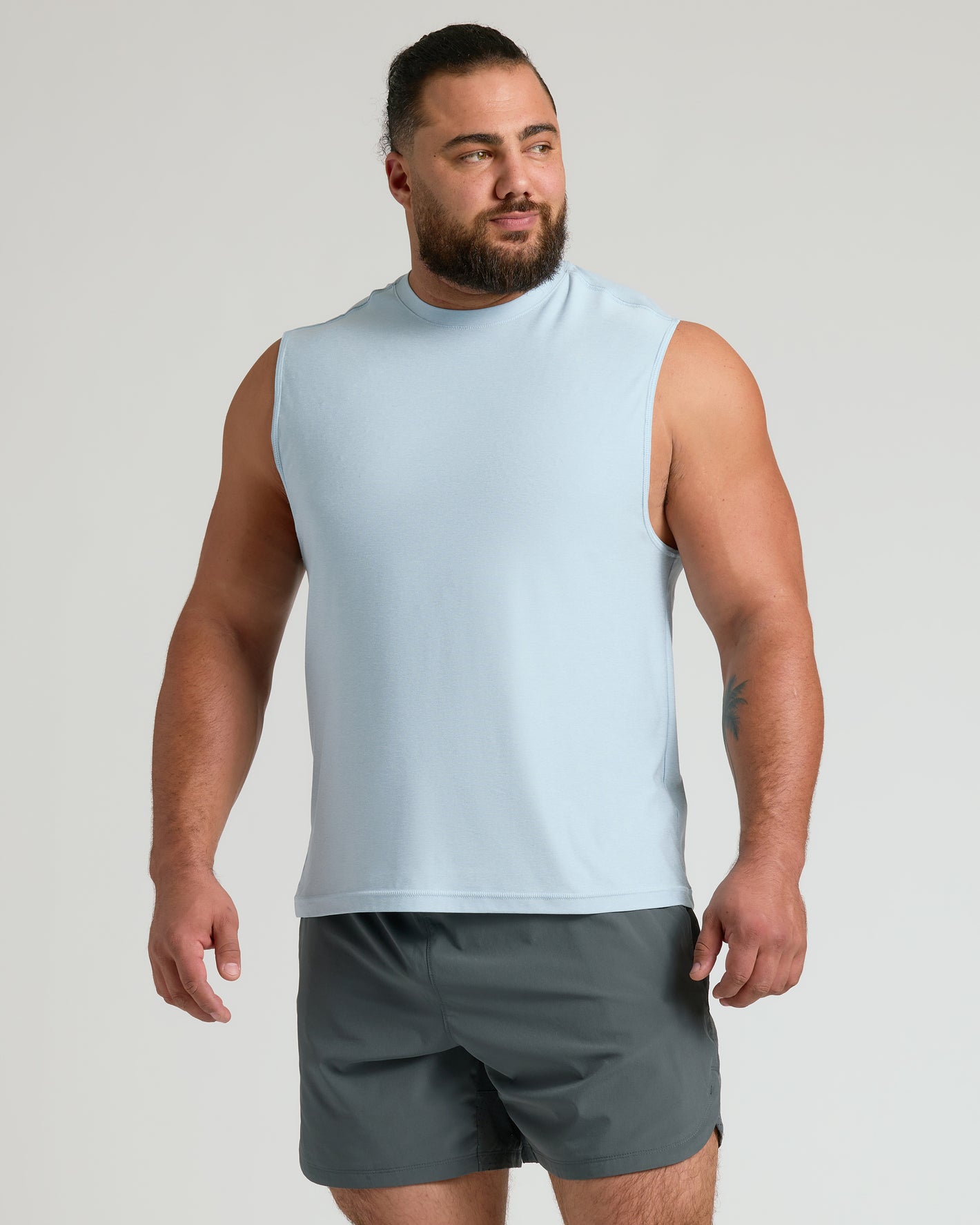 Male model in Limited Spring Sleeveless Active Muscle Tee 3-Pack.