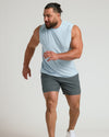 Man wearing Arctic Sleeveless Active Muscle Tee, poised to sprint.