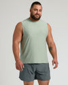 Man in Limited Sleeveless Active Muscle Tee, sage-green, with relaxed posture.