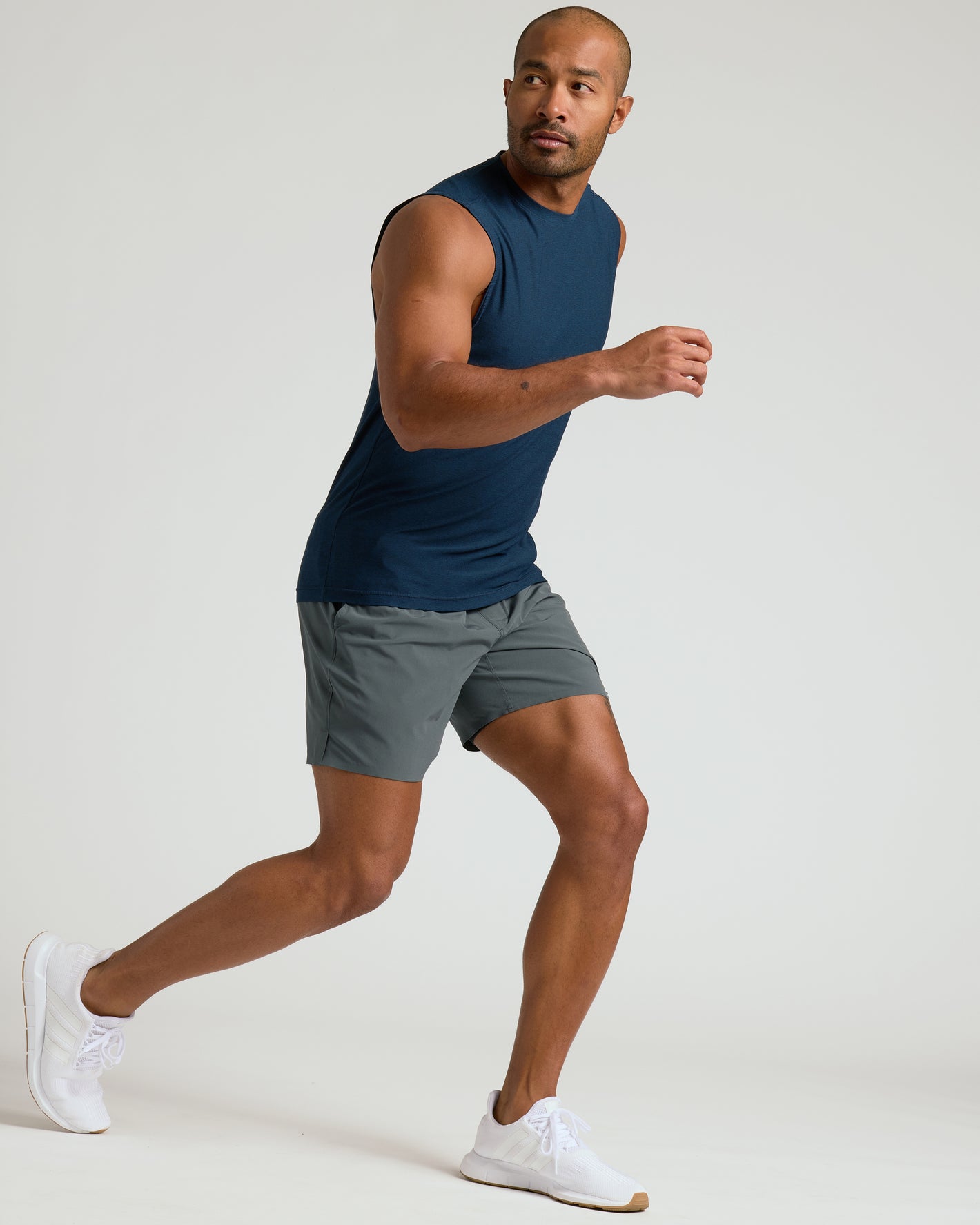 Man running in Dark Heather Navy Sleeveless Active Muscle Tee.