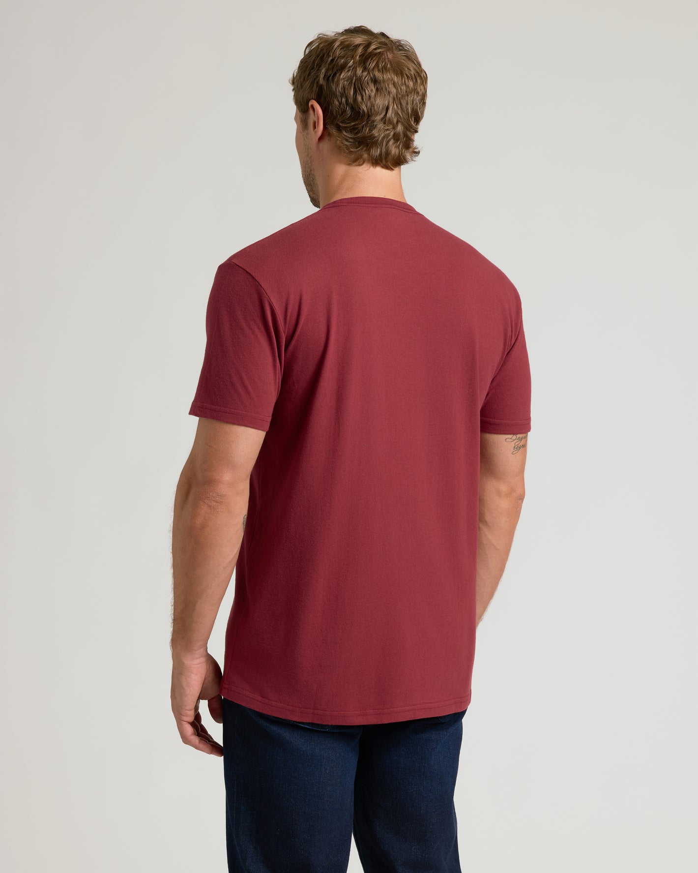 Back view of Claret Pocket Crew Tee on man, revealing fit.