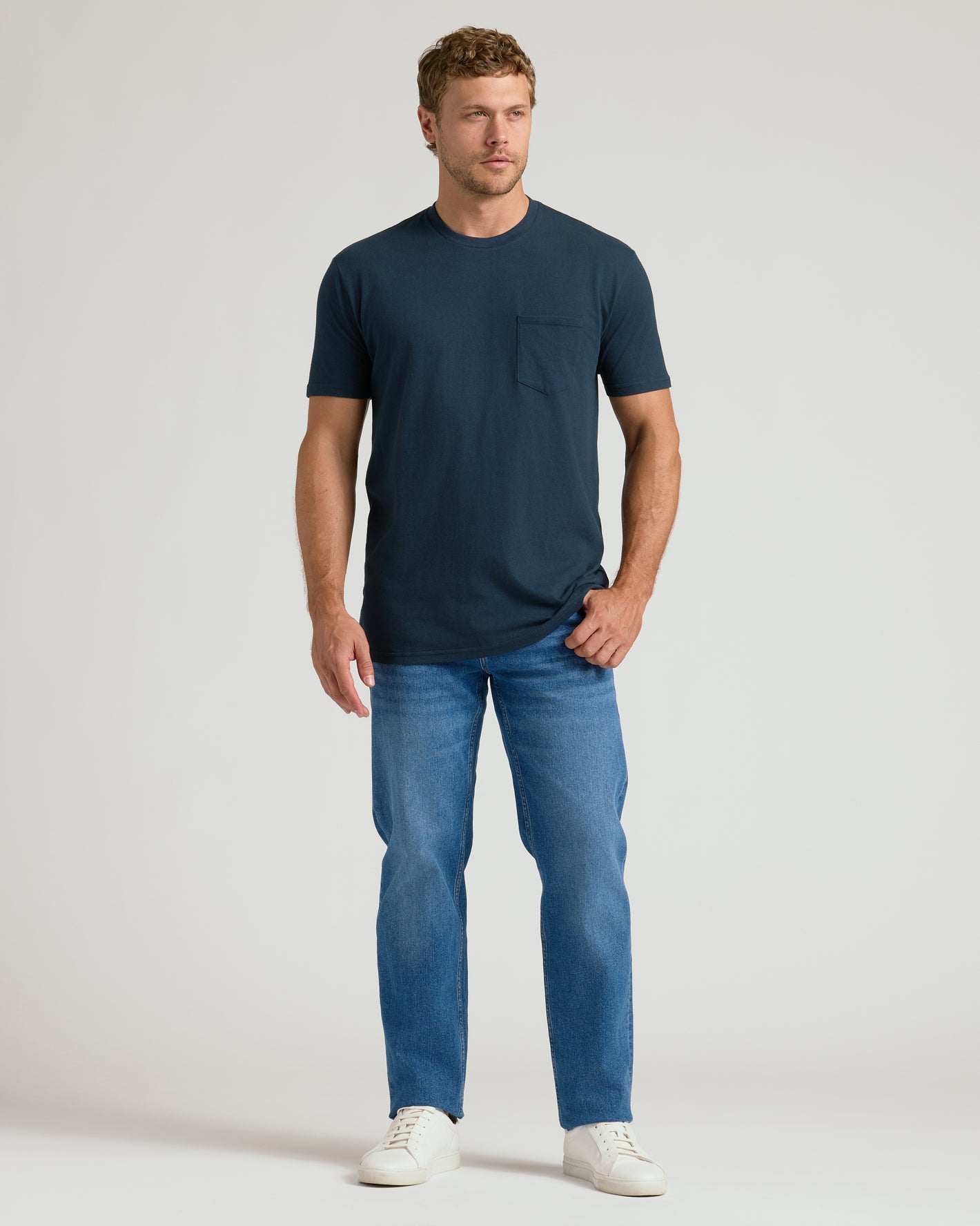 Model in Classic Pocket Crew 3-Pack outfit: dark teal/navy tee, mid-blue jeans.