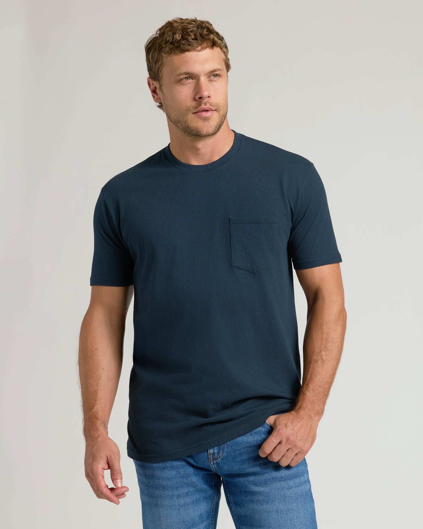 Man wearing Classic Pocket Crew 3-Pack T-shirt and jeans.