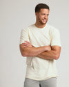 Man wearing Alabaster Tall Straight Hem Crew Neck T-Shirt, arms folded.