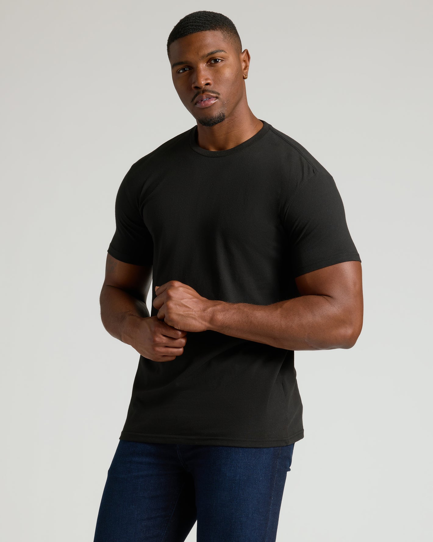 Model in All Black Tall Classic Crew T-shirt and jeans.